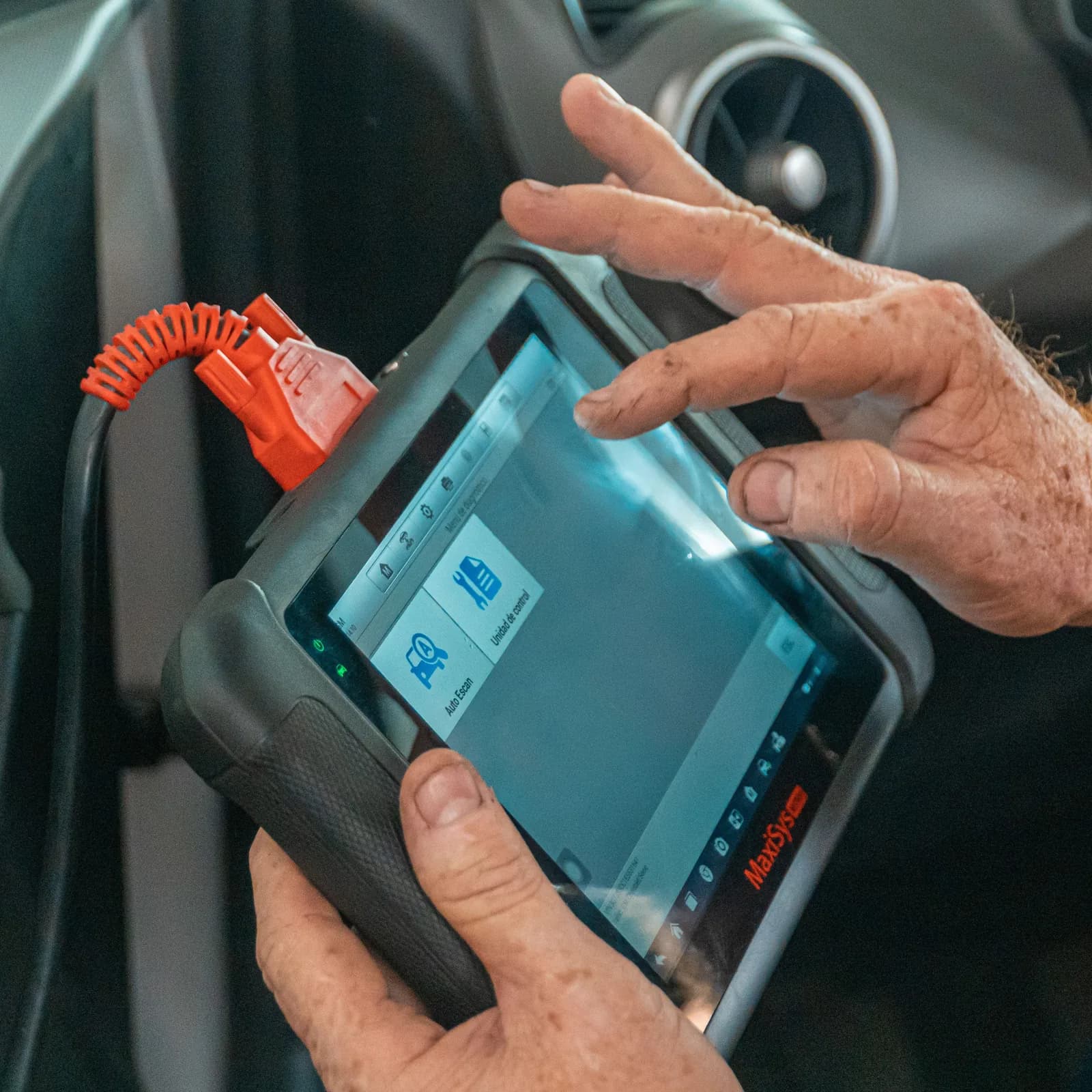 Scan tool plugged into a vehicle, reading fault codes from the control units